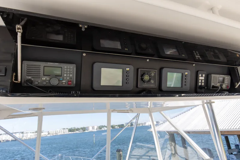Slide: The Image of Control panel of a 1998 Hatteras 60 Convertible yacht with navigation equipment. - 33