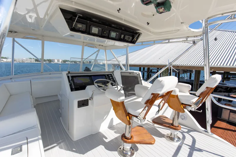 Slide: The Image of Cockpit of 1998 Hatteras 60 Convertible yacht with helm and seating. - 31
