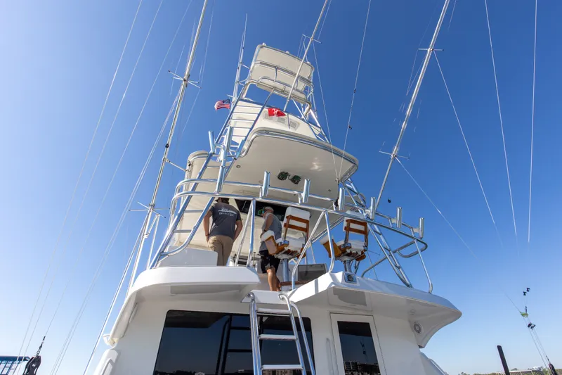 Slide: The Image of 1998 Hatteras 60 Convertible yacht with tower against clear blue sky. - 26