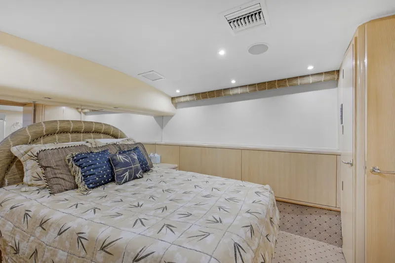 Slide: The Image of Luxurious bedroom interior of 1998 Hatteras 60 Convertible yacht with elegant bedding. - 19