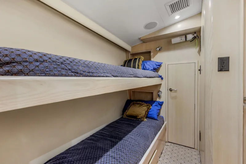 Slide: The Image of Interior of 1998 Hatteras 60 Convertible yacht with cozy bunk beds and elegant decor. - 15