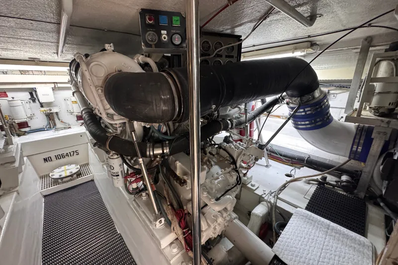 Slide: The Image of Engine room of a 1998 Hatteras 60 Convertible yacht, showcasing machinery and components. - 37