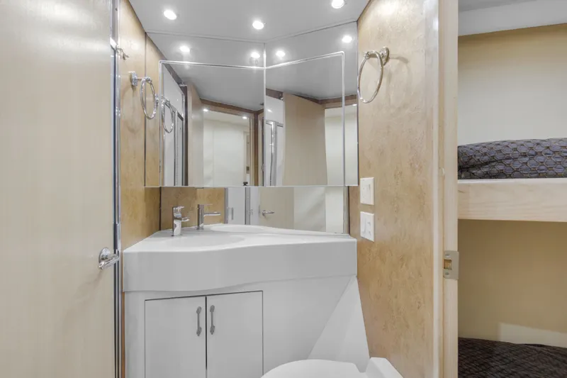 Slide: The Image of Bathroom interior of 1998 Hatteras 60 Convertible yacht with modern fixtures and lighting. - 17