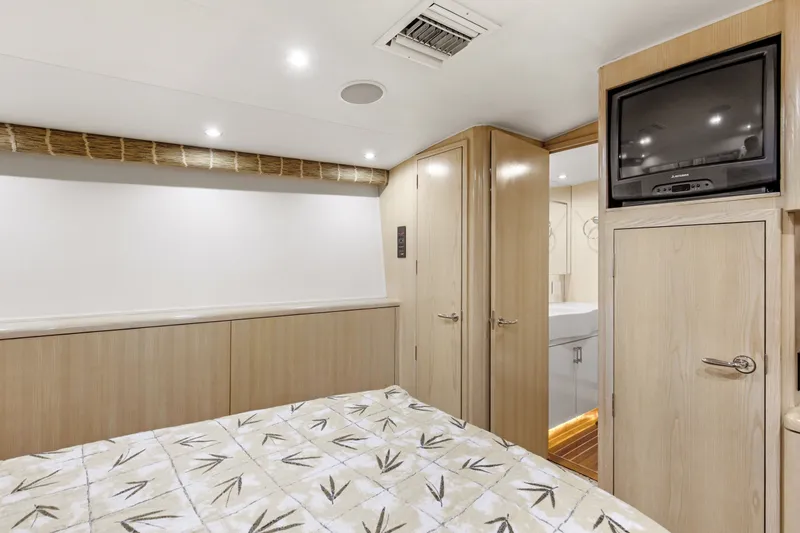 Slide: The Image of Interior cabin of 1998 Hatteras 60 Convertible yacht with TV and wooden cabinetry. - 21