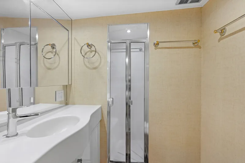 Slide: The Image of Bathroom interior of 1998 Hatteras 60 Convertible yacht, featuring modern fixtures and shower. - 18
