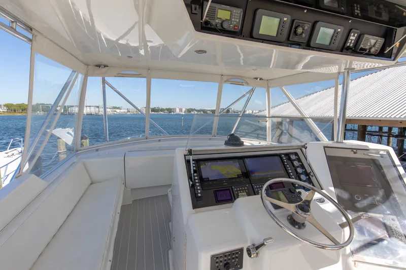 Slide: The Image of Cockpit of 1998 Hatteras 60 Convertible yacht with navigation equipment and waterfront view. - 29