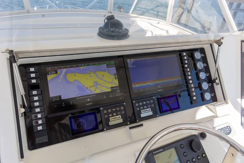 Slide: The Image of Control panel of a 1998 Hatteras 60 Convertible yacht with navigation displays. - 32