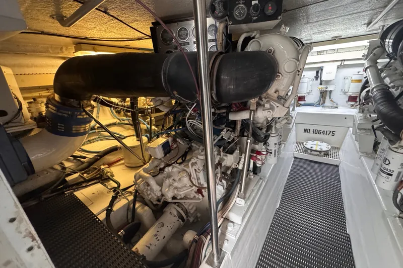 Slide: The Image of Engine room of a 1998 Hatteras 60 Convertible yacht, showcasing machinery and components. - 36