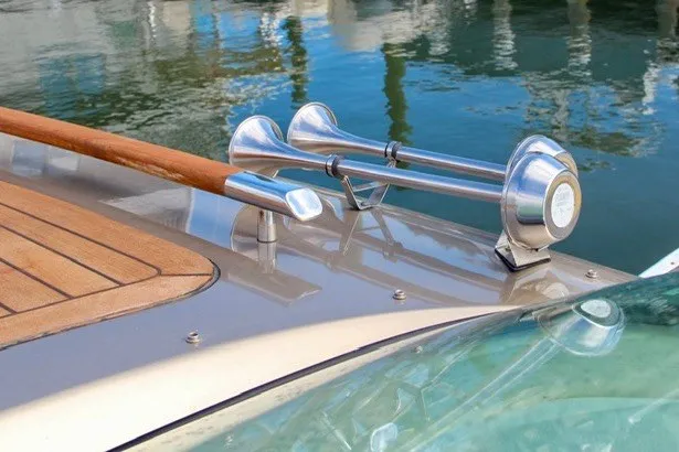 Slide: The Image of 2013 Chris-Craft Corsair 32 boat deck with polished horn and wooden accents. - 11