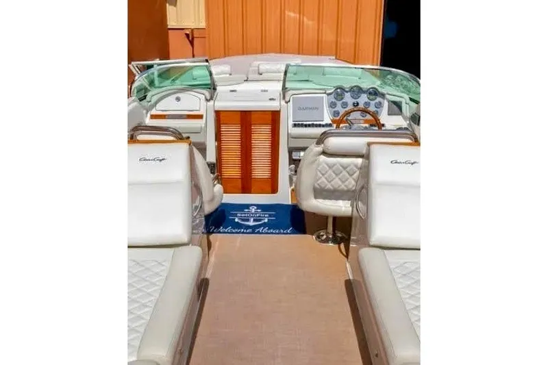 Slide: The Image of Interior view of 2013 Chris-Craft Corsair 32 boat with luxurious seating and dashboard. - 10