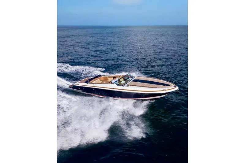 Slide: The Image of 2013 Chris-Craft Corsair 32 cruising on open water, showcasing sleek design and performance. - 1