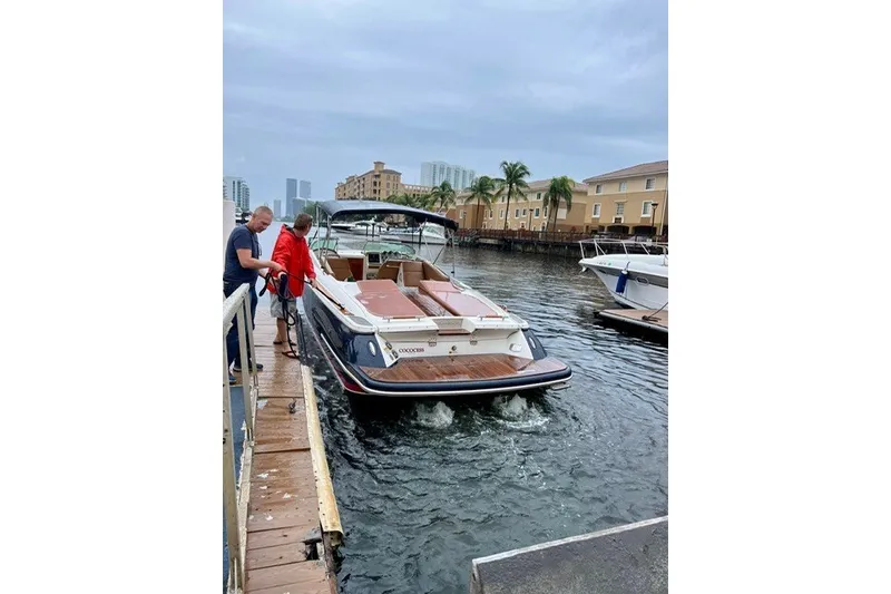 Slide: The Image of 2013 Chris-Craft Corsair 32 docked, with people boarding, in a marina setting. - 5