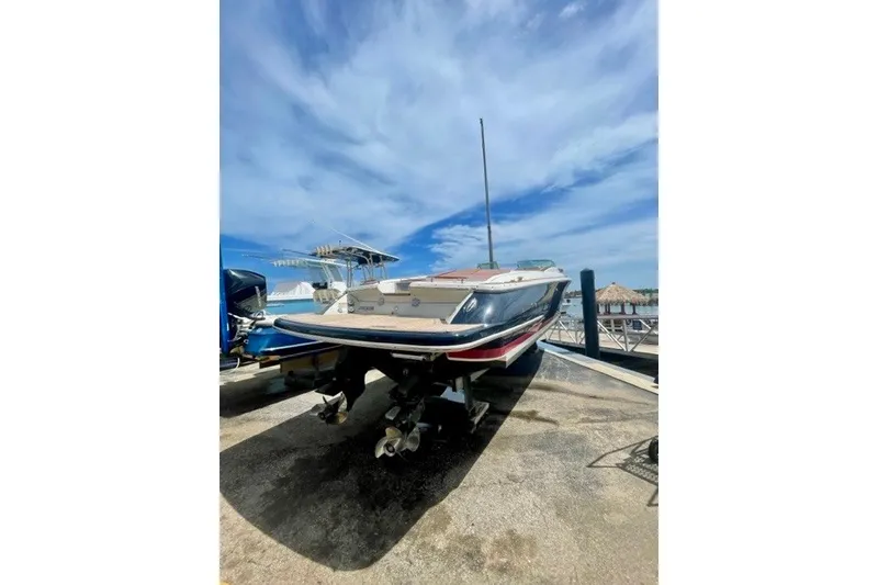 Slide: The Image of 2013 Chris-Craft Corsair 32 boat on a dock under a clear blue sky. - 4