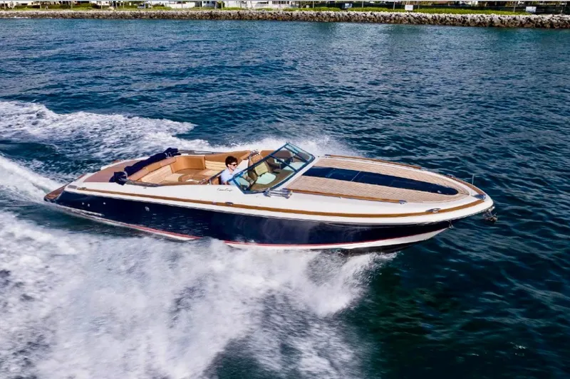 Slide: The Image of 2013 Chris-Craft Corsair 32 cruising on open water, showcasing sleek design and performance. - 0