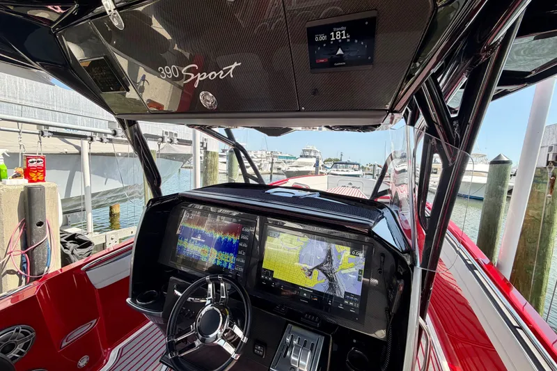 Slide: The Image of Interior view of a 2022 Nor-Tech 390 Sport boat with advanced navigation displays. - 52