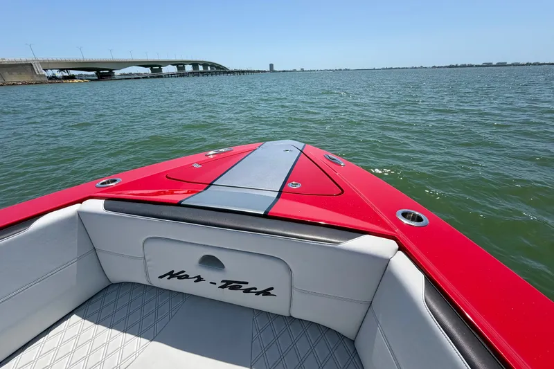 Slide: The Image of 2022 Nor-Tech 390 Sport boat on water near a bridge, showcasing sleek design. - 37
