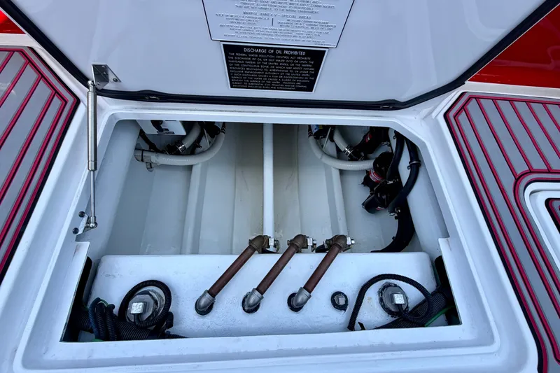 Slide: The Image of 2022 Nor-Tech 390 Sport engine compartment with visible hoses and fittings. - 62