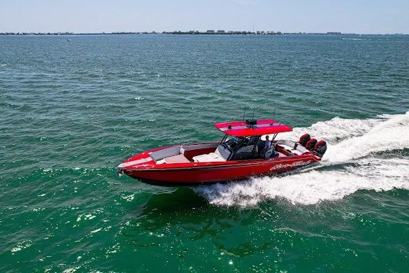 Slide: The Image of Red 2022 Nor-Tech 390 Sport boat cruising on open water. - 30