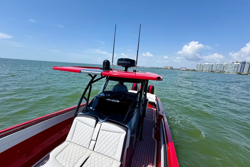 Slide: The Image of 2022 Nor-Tech 390 Sport boat cruising on open water under clear blue skies. - 40