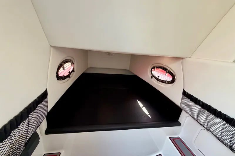 Slide: The Image of Interior cabin of 2022 Nor-Tech 390 Sport boat with portholes and storage nets. - 60