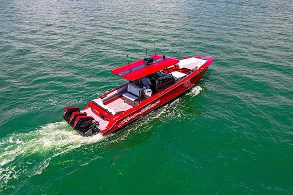 Slide: The Image of Red 2022 Nor-Tech 390 Sport boat cruising on open water. - 21