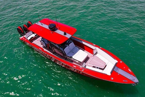 Slide: The Image of 2022 Nor-Tech 390 Sport boat in vibrant red on clear green water. - 13