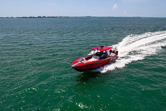 Slide: The Image of Red 2022 Nor-Tech 390 Sport boat cruising on open water. - 29