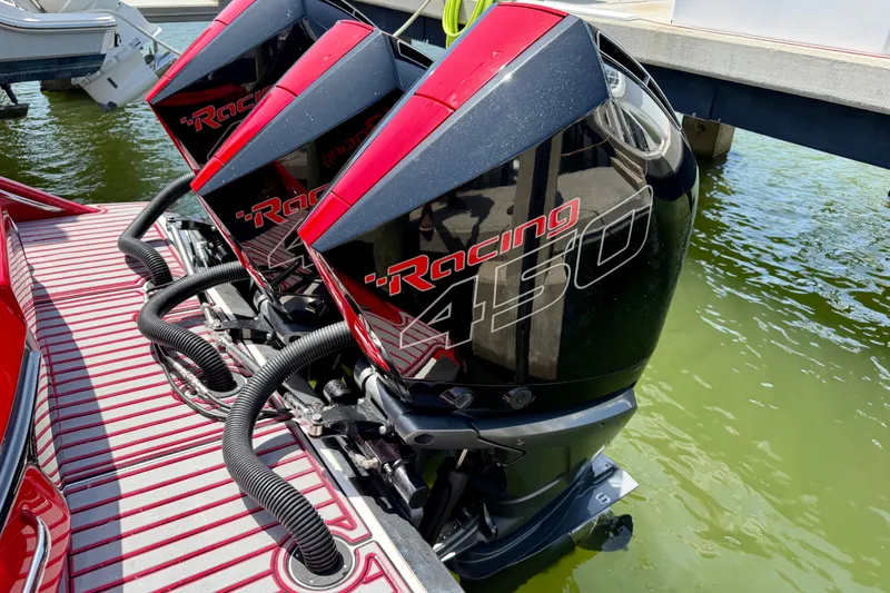 Slide: The Image of Triple Mercury Racing 450 engines on a 2022 Nor-Tech 390 Sport boat. - 68