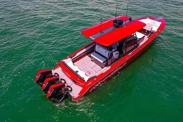 Slide: The Image of 2022 Nor-Tech 390 Sport boat in vibrant red on open water. - 12