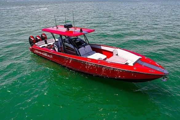 Slide: The Image of Red 2022 Nor-Tech 390 Sport boat on open water, featuring sleek design and powerful engines. - 7