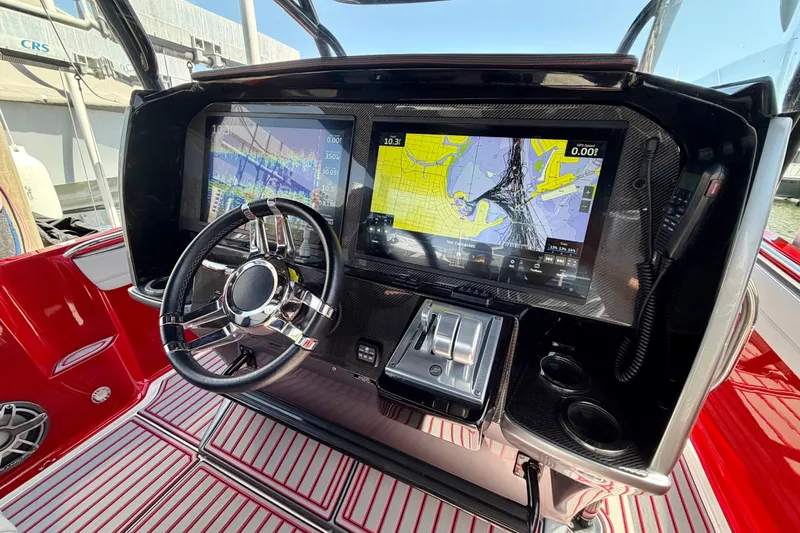 Slide: The Image of 2022 Nor-Tech 390 Sport dashboard with advanced navigation screens and sleek steering wheel. - 54