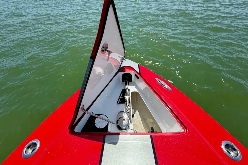 Slide: The Image of Red 2022 Nor-Tech 390 Sport boat with open anchor hatch on water. - 38