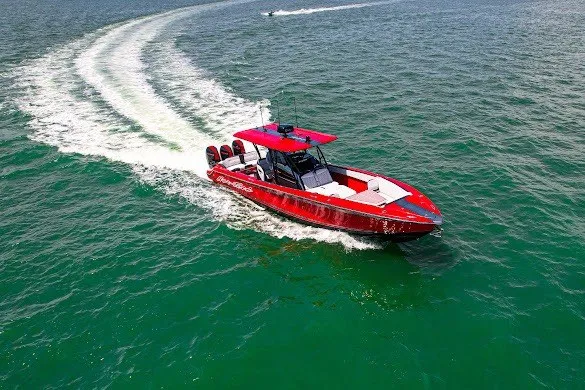 Slide: The Image of Red 2022 Nor-Tech 390 Sport boat cruising on open water. - 28
