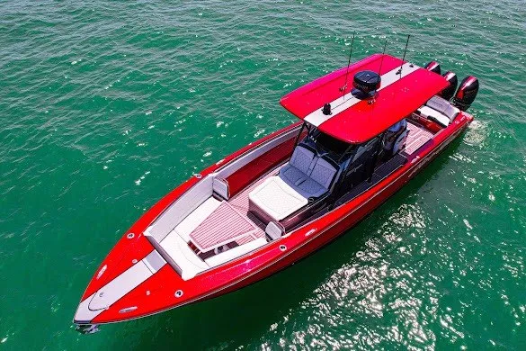Slide: The Image of 2022 Nor-Tech 390 Sport boat in vibrant red on clear green water. - 14
