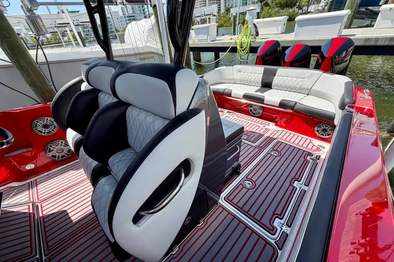 Slide: The Image of Luxurious 2022 Nor-Tech 390 Sport boat interior with stylish seating and vibrant red accents. - 58