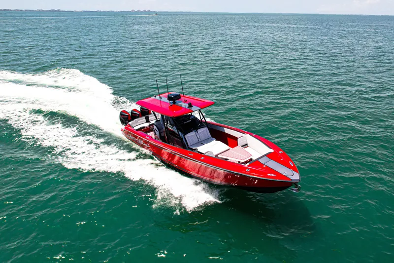 Slide: The Image of 2022 Nor-Tech 390 Sport boat cruising on open water, vibrant red design. - 23