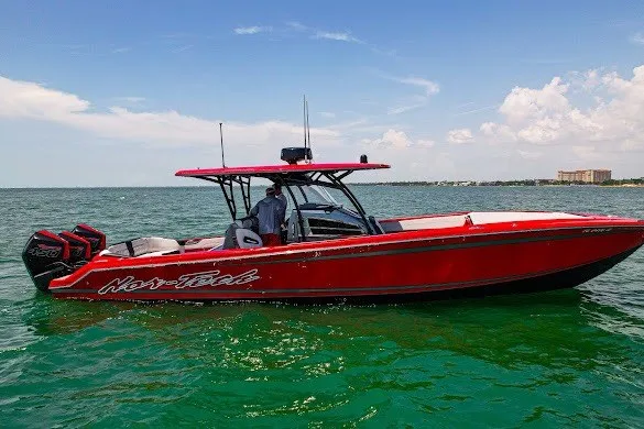 Slide: The Image of 2022 Nor-Tech 390 Sport boat in vibrant red on open water. - 6