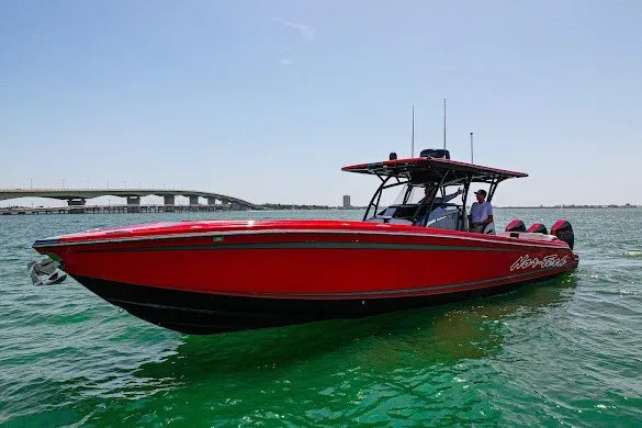 Slide: The Image of 2022 Nor-Tech 390 Sport boat in vibrant red on clear water. - 4
