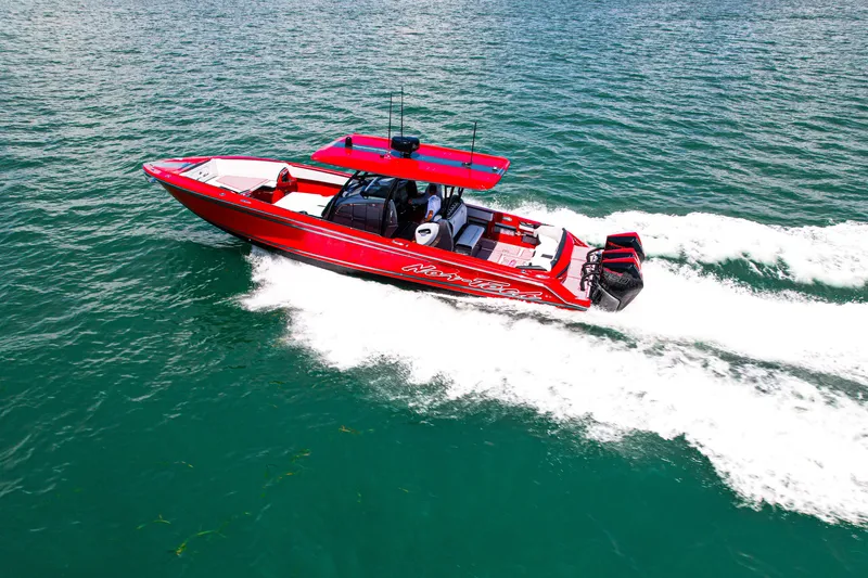 Slide: The Image of Red 2022 Nor-Tech 390 Sport boat cruising on open water, showcasing sleek design and performance. - 22