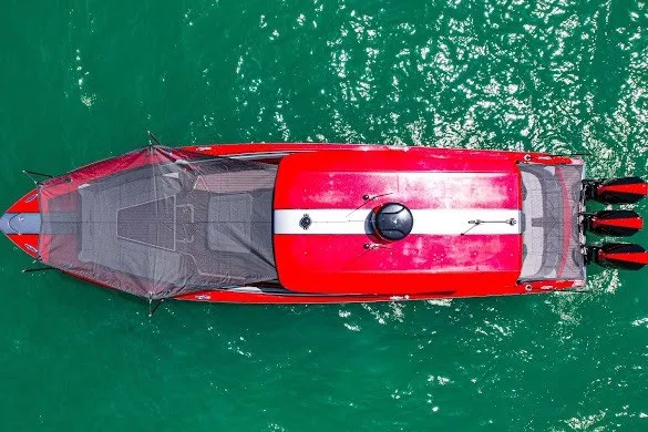 Slide: The Image of Aerial view of 2022 Nor-Tech 390 Sport boat in vibrant red on turquoise water. - 17