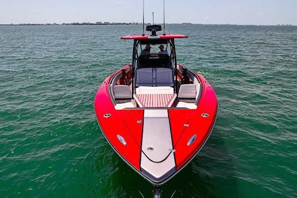 Slide: The Image of Red 2022 Nor-Tech 390 Sport boat on open water, front view. - 15