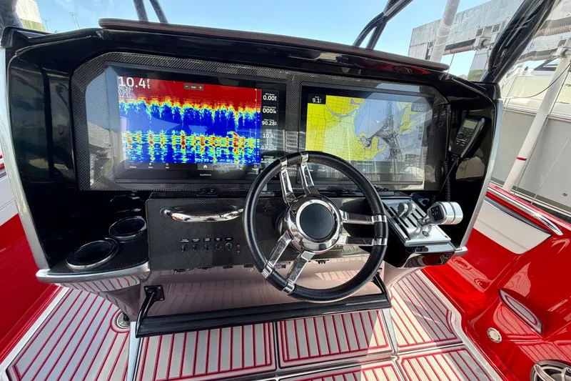 Slide: The Image of 2022 Nor-Tech 390 Sport dashboard with dual displays and modern steering wheel. - 55