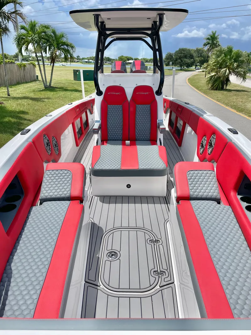 Slide: The Image of The image shows the interior of a 2025 Concept 32' CC boat with red and gray seating. - 9