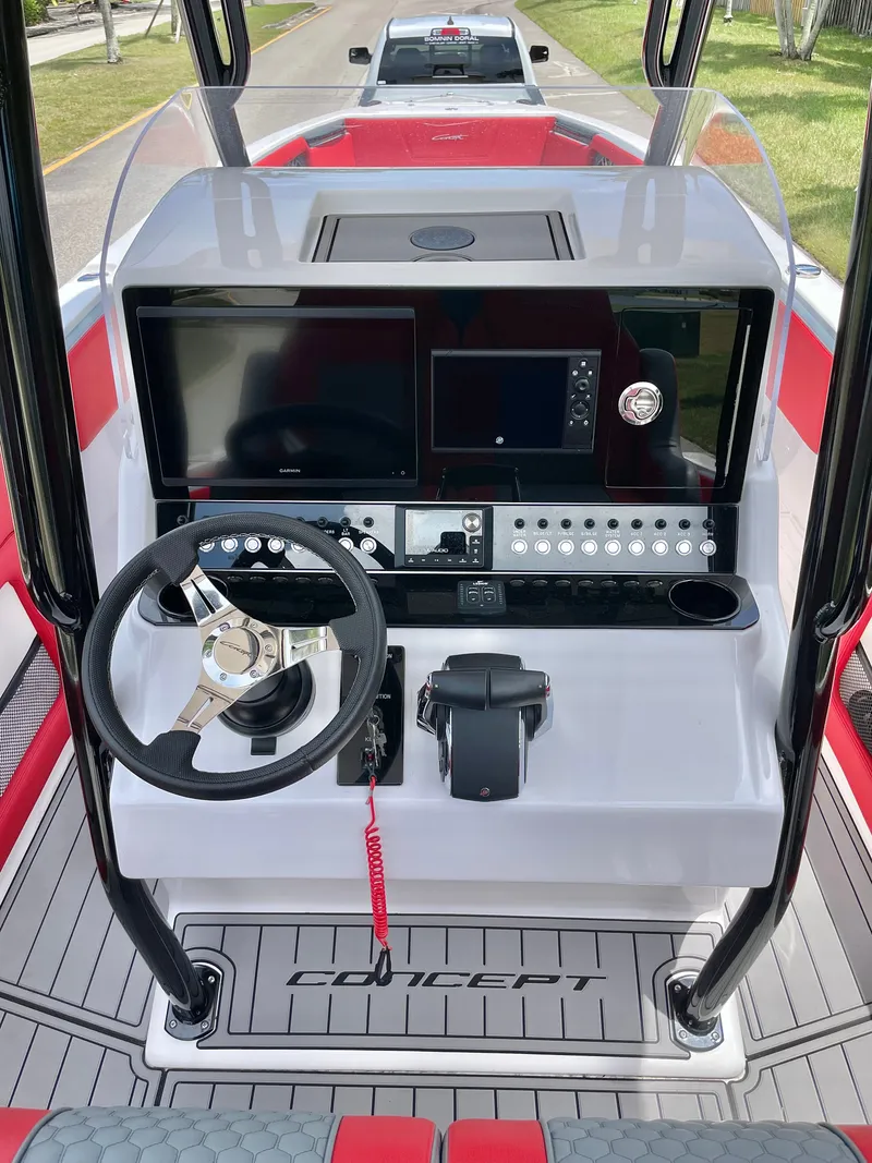 Slide: The Image of The image shows the cockpit of a 2025 Concept 32' CC boat with modern instruments. - 6