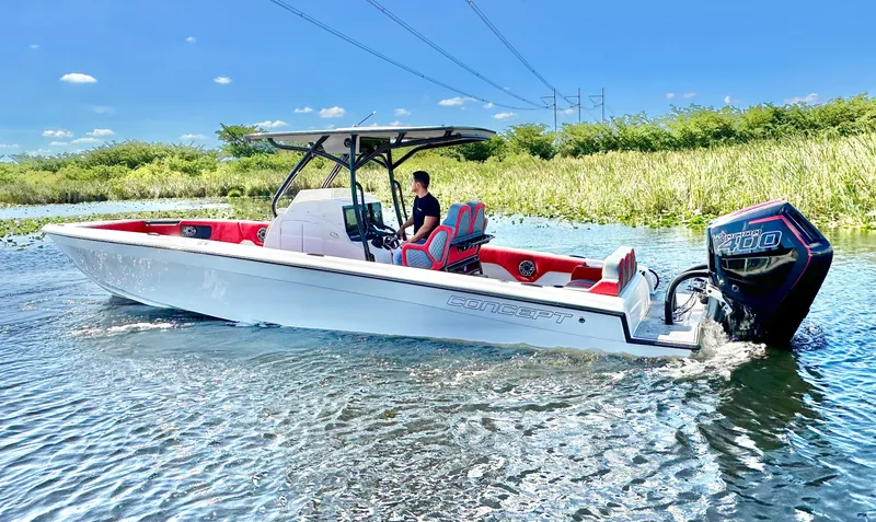 The Image of A modern white 32-foot boat with red accents cruising on calm waters. - 1