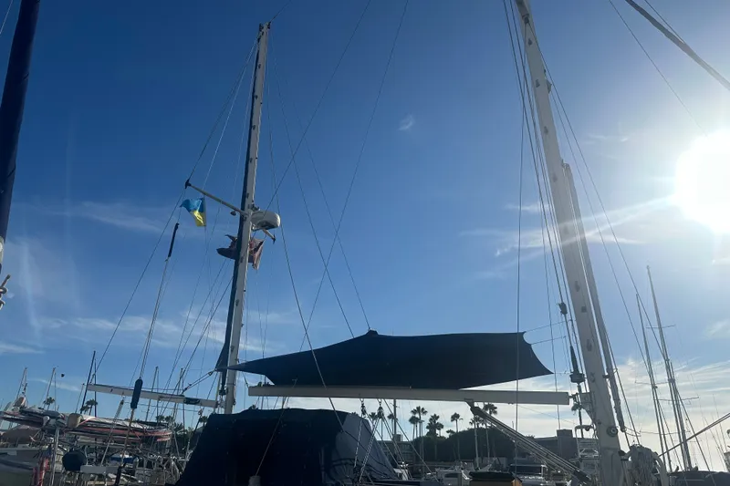 Slide: The Image of Sailboat DownEaster 45 from 1977 docked under clear blue sky with sun shining. - 18