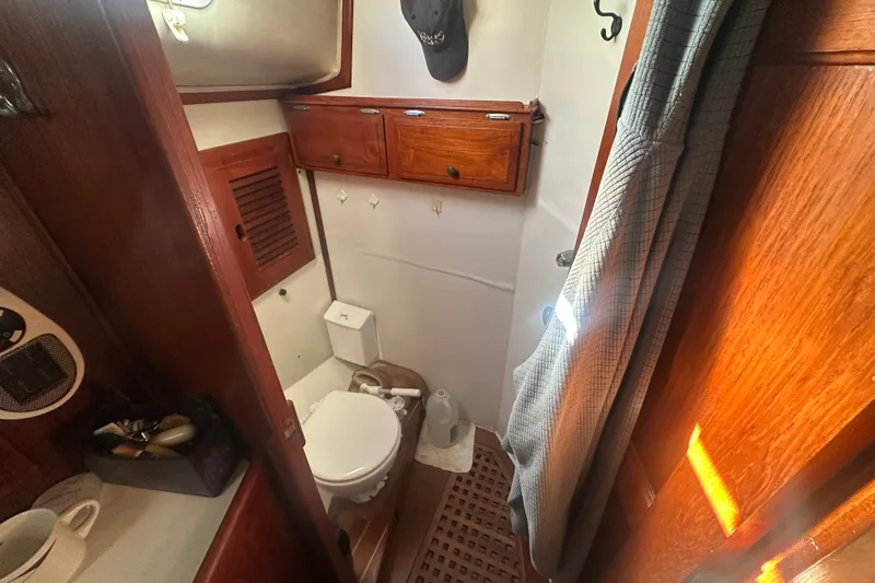 Slide: The Image of 1977 Down East Yachts DownEaster 45 bathroom with wooden cabinets and nautical decor. - 31