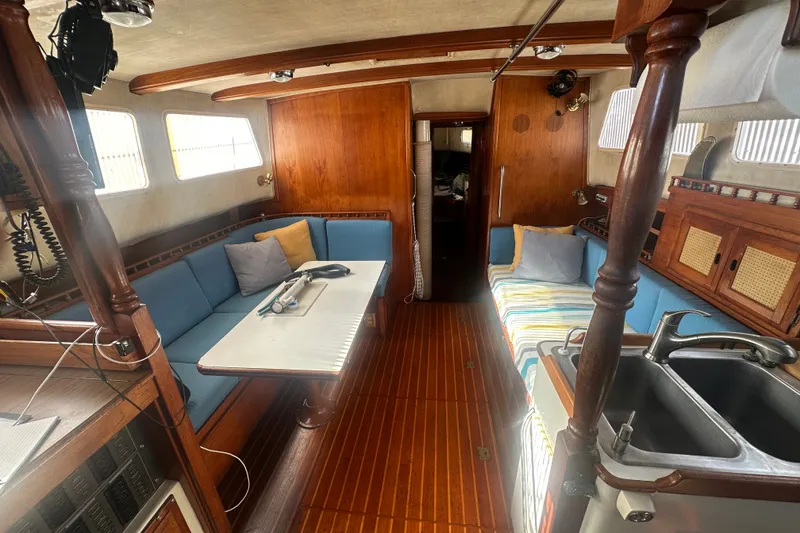 Slide: The Image of Interior of a 1977 Down East Yachts DownEaster 45 sailboat with cozy seating and wooden finishes. - 20