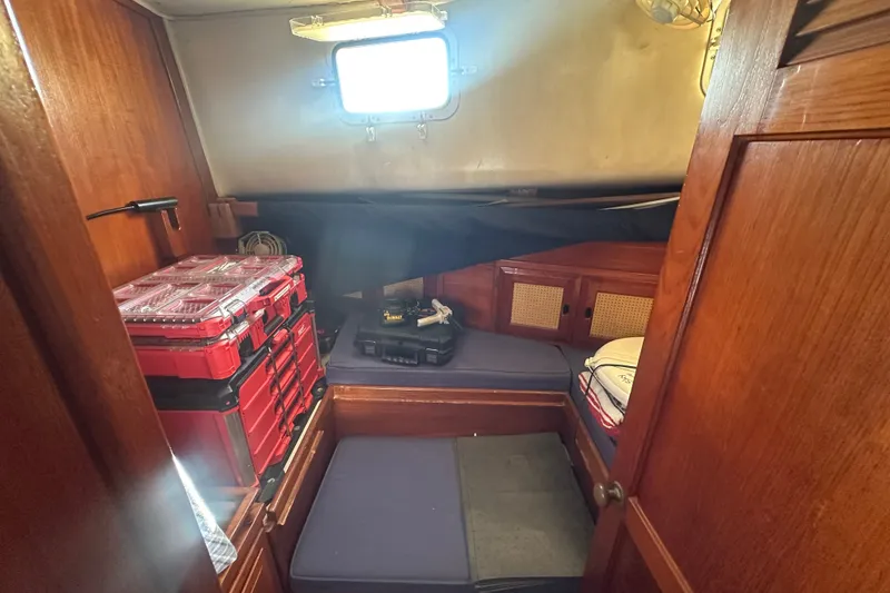 Slide: The Image of Cozy cabin interior of 1977 DownEaster 45 yacht with storage boxes and cushions. - 26