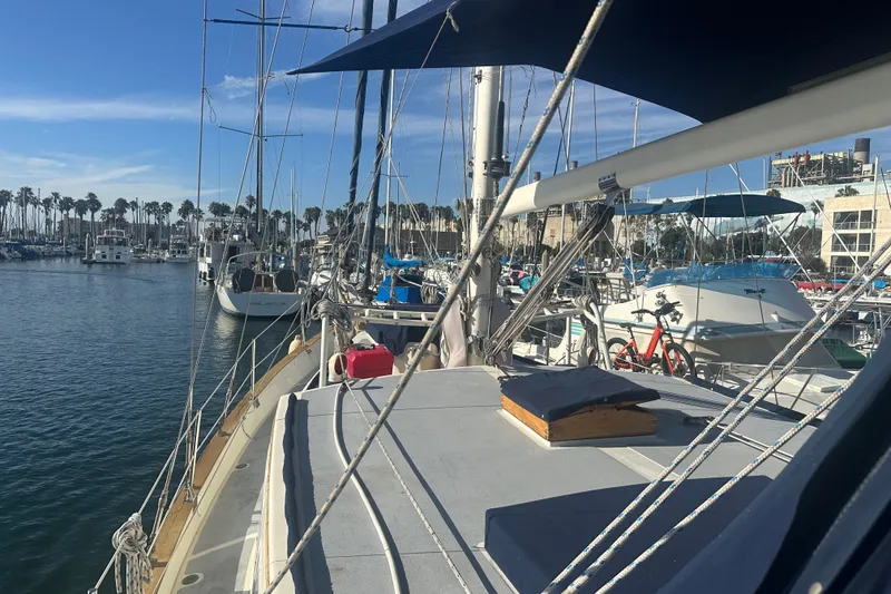 Slide: The Image of 1977 Down East Yachts DownEaster 45 sailboat docked in a sunny marina. - 14